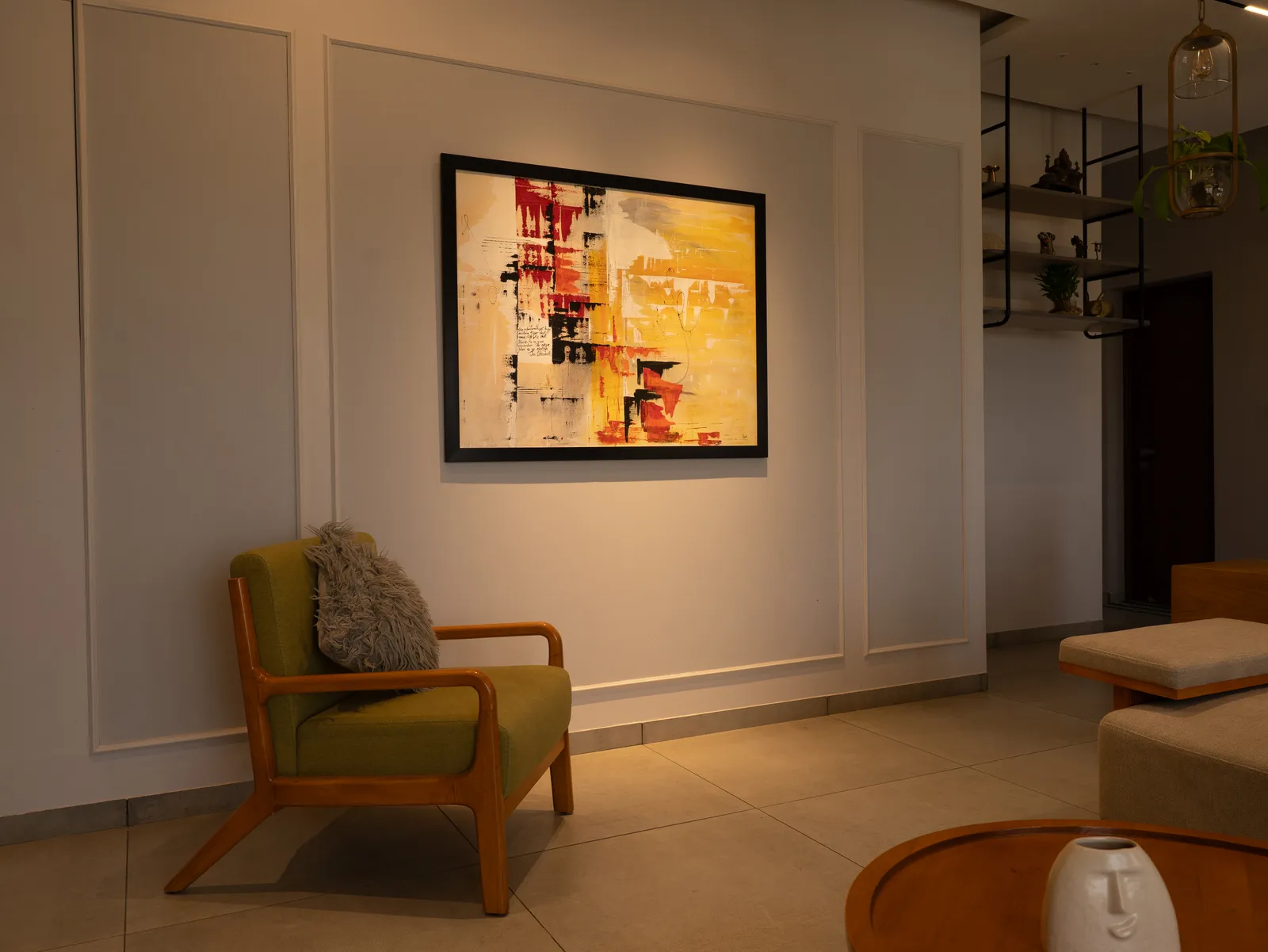 Reading corner with green armchair and abstract artwork — Amlan's Residence